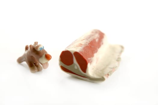 Handmade hungry plasticine dogs withy some meat to eat