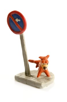plasticine handmade dog, pee on signal pole isolated over white