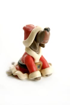Plasticine handmade dog, santa xmas dress isolated on white background