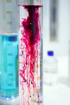 Laboratory stuff, glass cylinder vases, colorful liquids, chemical research