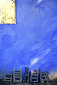 Grunge blue mediterranean garden texture wall, light and shadows