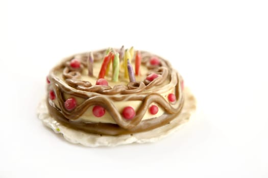 Toy plasticine happy birthday cake isolated over white background