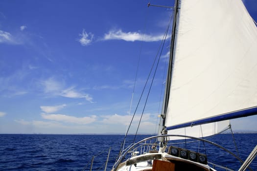 Sailboat sailing blue sea on sunny summer day in Mediterranean
