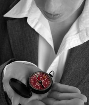 business woman, compass hand, looking for advices about which direction keep