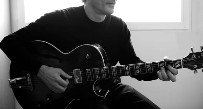 Jazz guitar player playing classic instrument