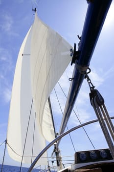 Sailboat sailing blue sea on sunny summer day in Mediterranean