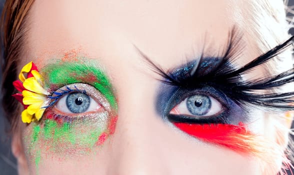 asymmetrical fantasy eyes makeup spring flowers and night black bird feathers