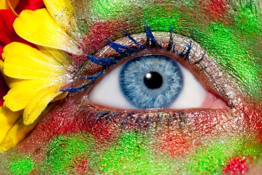 blue woman eye makeup inspired in spring with flowers meadow and yellow petals