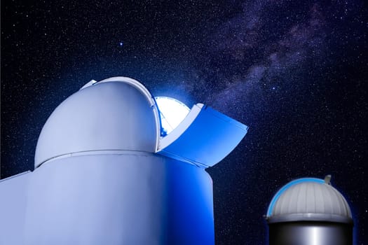 astronomical observatory dome in night with stars and glowing light