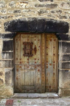Medieval wooden door in stone wall Pyrenees Aragon Spain