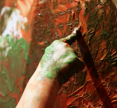 Children artist hands painting multi color with her fingers