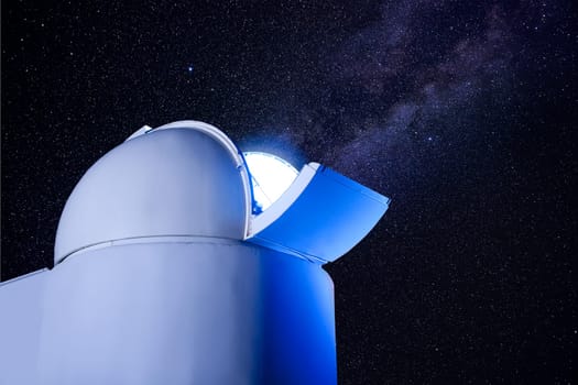 astronomical observatory dome in night with stars and glowing light