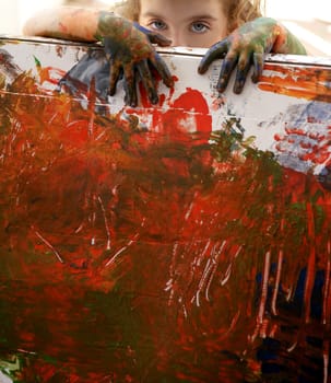 Children artist hands painting multi color with her fingers