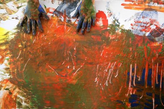 Children artist hands painting multi color with her fingers