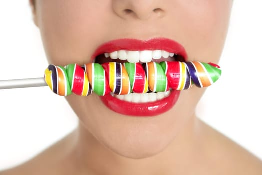 Colorful Lollypop in perfect woman teeth and red lips mouth