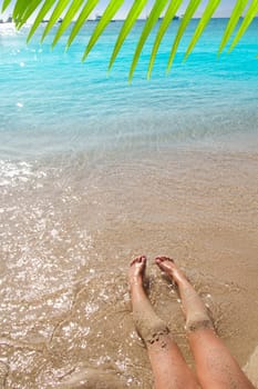 Children girl legs in beach sand shore at summer vacation
