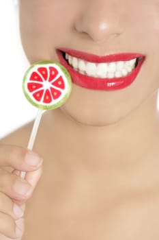Colorful Lollypop in perfect woman teeth and red lips mouth