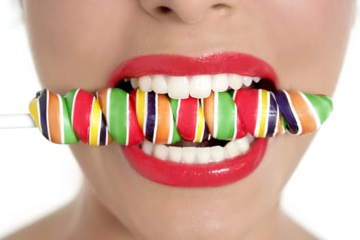 Colorful Lollypop in perfect woman teeth and red lips mouth