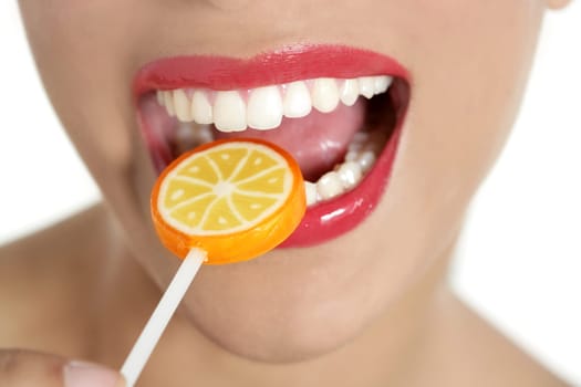 Colorful Lollypop in perfect woman teeth and red lips mouth