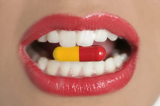 Beauty woman mouth with red lips and medicine pill