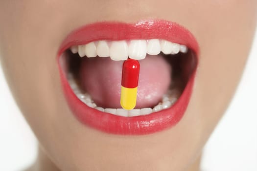 Beauty woman mouth with red lips and medicine pill
