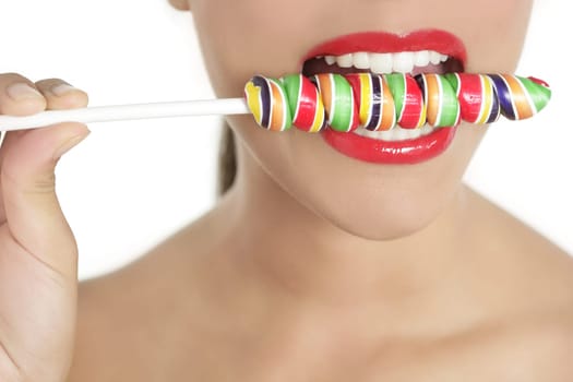 Colorful Lollypop in perfect woman teeth and red lips mouth