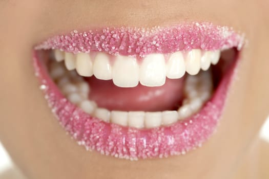 Lips of a woman in sugar pink liptstick makeup macro