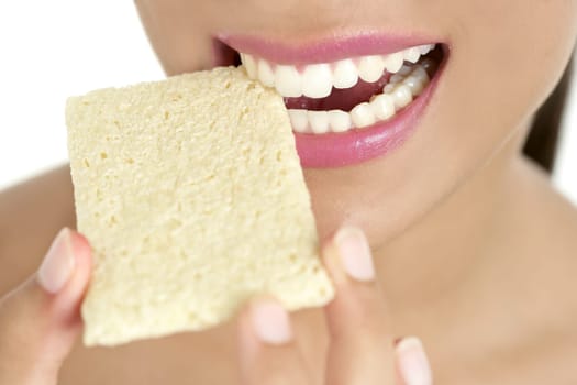 Biscuit in woman teeth and mouth having a healthy snack