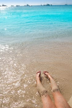 Children girl legs in beach sand shore at summer vacation