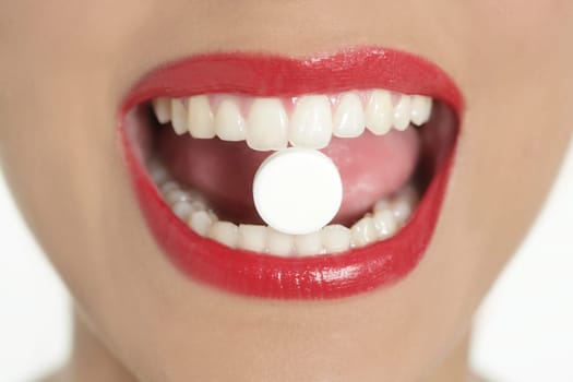 Beauty woman mouth with red lips and medicine pill