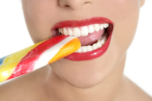 Colorful Lollypop in perfect woman teeth and red lips mouth