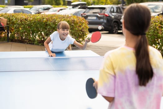 girl plays in table tennis outdoor. High quality photo