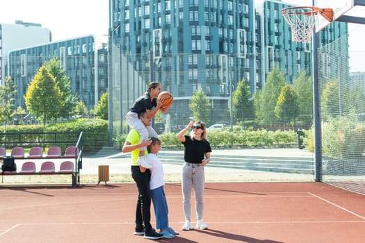 Caucasian family playing basketball together. Happy family spending free time together. High quality photo