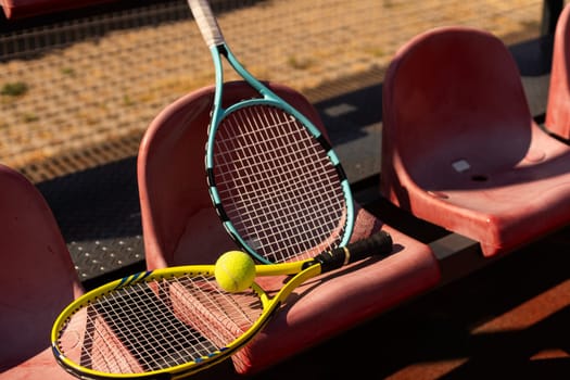 Close up view of tennis racket and balls on the clay tennis court. High quality photo