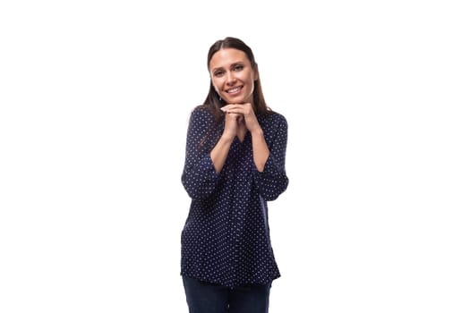 young smiling slender woman with black hair dressed in a blue blouse.