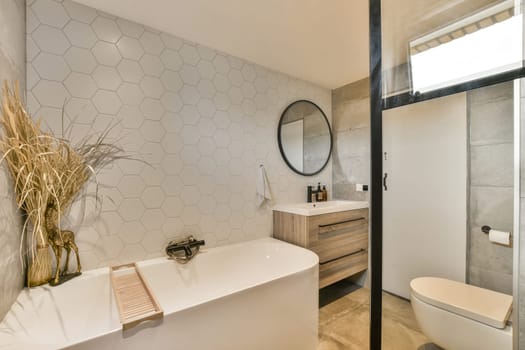 a modern bathroom with hexagon tiles on the wall and wood cabinets in the corner, along with a toilet