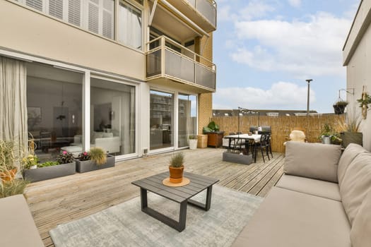 an outdoor living area with patio furniture and large sliding glass doors that open up to the outside terraced space