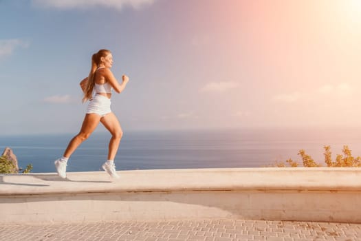 Fitness woman sea. Outdoor workout on yoga mat in park near to ocean beach. Female fitness pilates yoga routine concept. Healthy lifestyle. Happy fit woman exercising with rubber band in park.