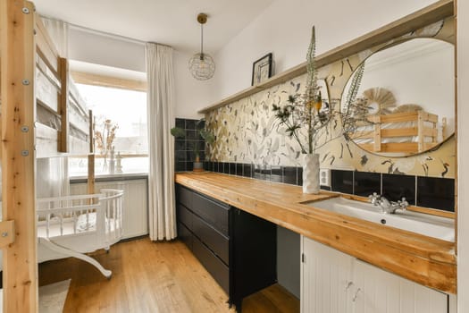 a kitchen with black and white tiles on the wall behind it is a wooden counter that has been used as a sink