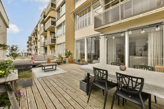 an outdoor living area with patio furniture and large sliding glass doors that open up to the outside decking space