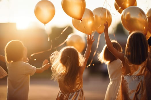 Children with balloons in nature in the rays of sunset. Holiday for children. Happy childhood.