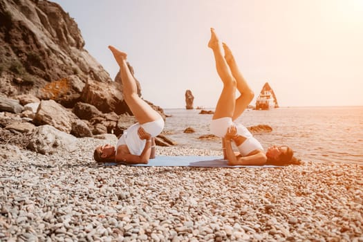 Woman sea yoga. Back view of free calm happy satisfied woman with long hair standing on top rock with yoga position against of sky by the sea. Healthy lifestyle outdoors in nature, fitness concept.