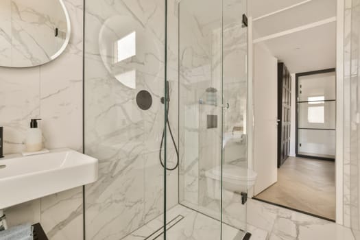 a modern bathroom with marble flooring and white walls there is a large mirror on the wall above the shower
