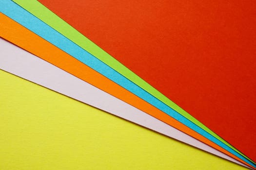 Sheets of colored paper as concept of creativity and diversity. Modern colored background.