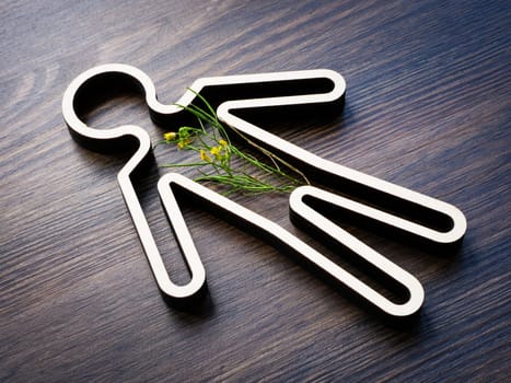 The outline of a person and the plant inside as a symbol of vitality and wellbeing.