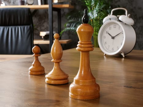 Chess pieces stand on the table as symbol of career, professional growth and corporate hierarchy.