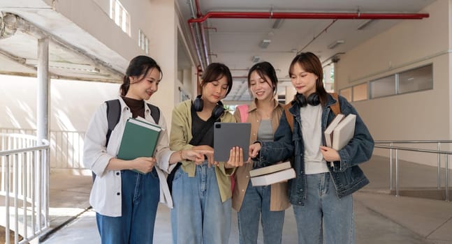 Happy young student chat with each other after class. Guy and girls wear casual clothes to study. Lifestyle concept, sincere emotions.
