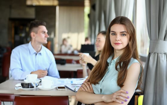 young beautiful woman have meeting with her subordinates in cafe