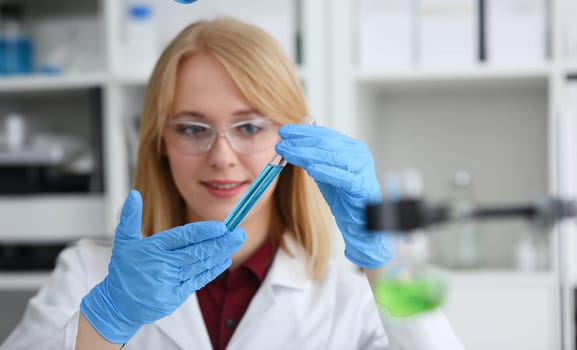 Technician hold in arms in protective gloves sample bottle with poison fluid portrait. Medical worker in uniform use reagent tube for virus infection exam or biological toxic reaction drug creation