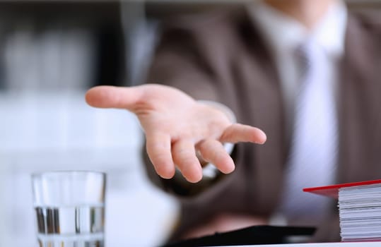 Male in suit and tie offer helping arm closeup. Friendly cheerful assist move wise choice concern visit solve problem provide advisor rescue management inspiration negotiation concept